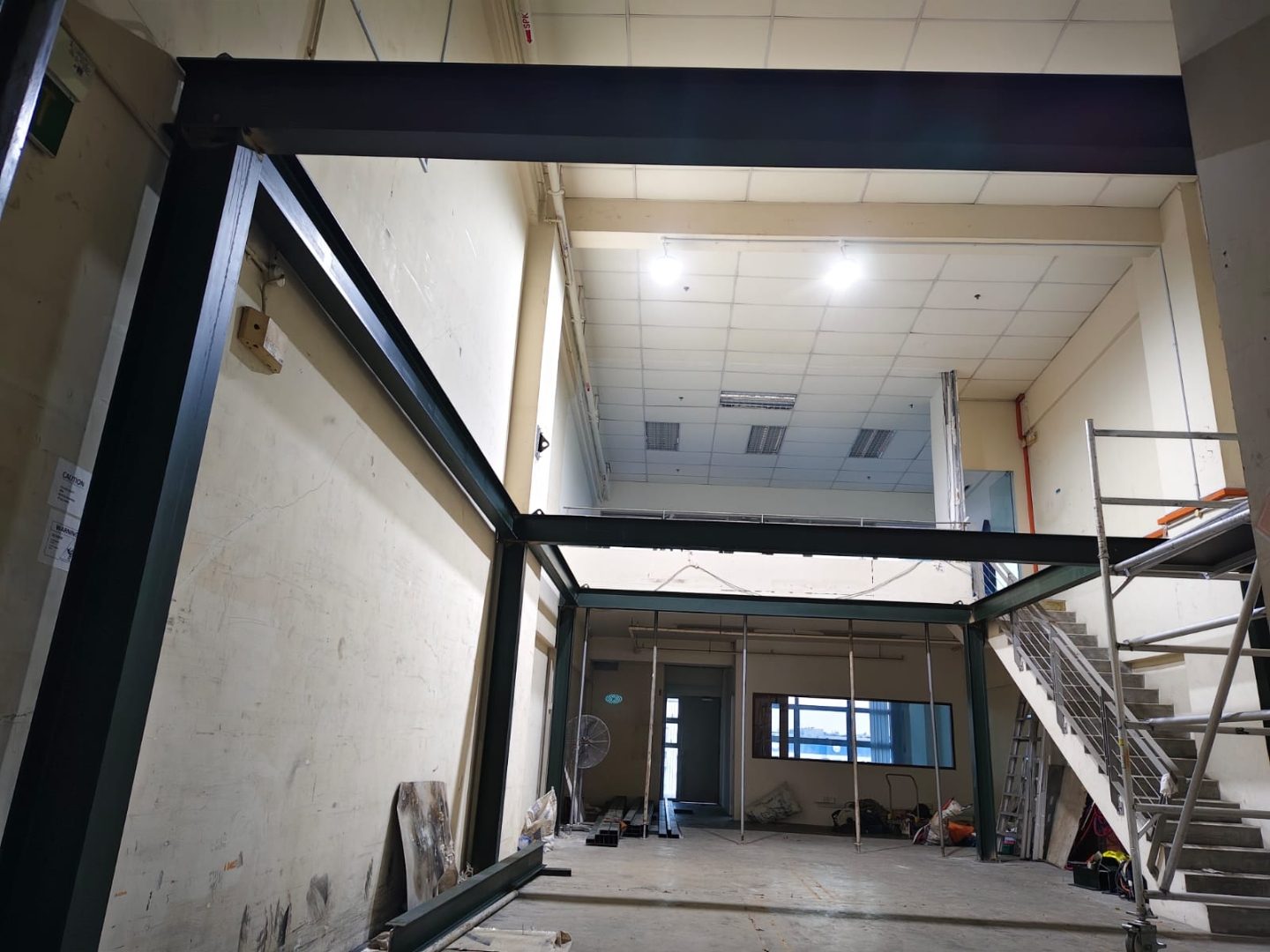 Completed mezzanine steel frame at Frontier Industrial Building viewed from the lower floor with the elevated platform set against the existing wall