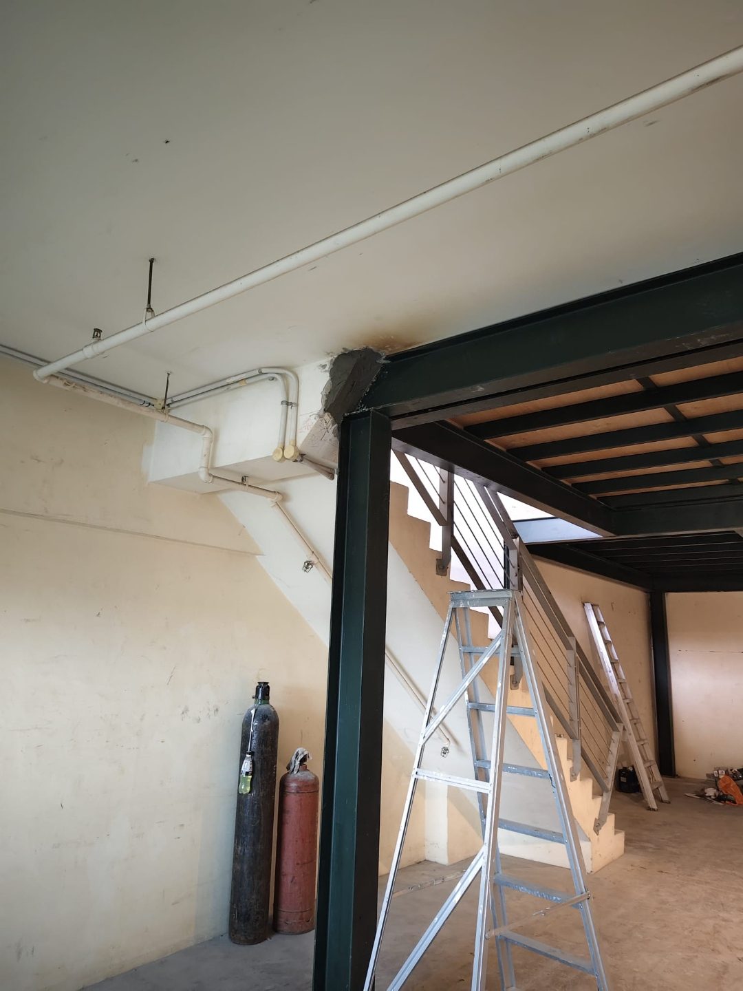 Edge of the mezzanine opening at Frontier Industrial Building showing the steel frame against the existing wall