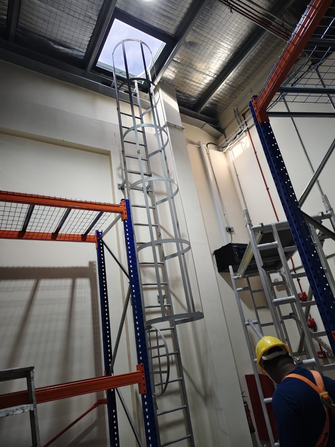 Interior cat ladder at Wan Lee rising between racking to the underside of the roof access opening