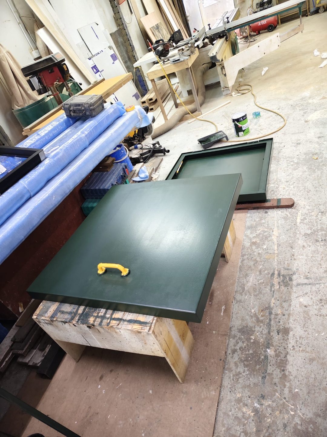 Roof access hatch panel laid out on workbench during fabrication for the Wan Lee project